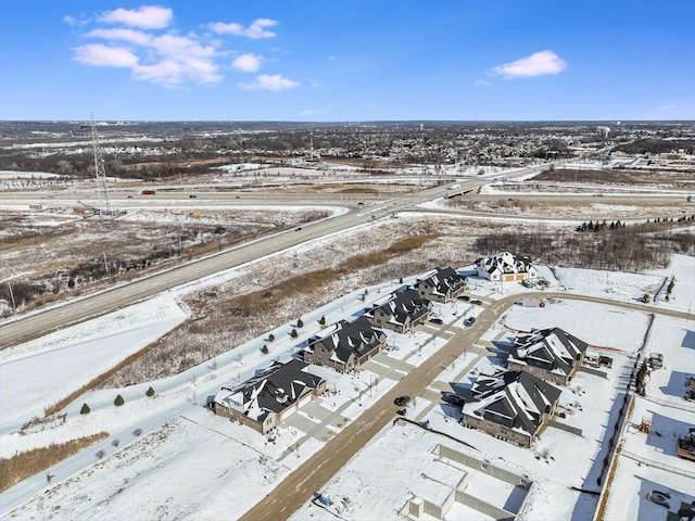 snowy aerial view featuring a residential view