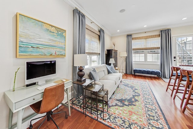 living area with ornamental molding, recessed lighting, and wood finished floors