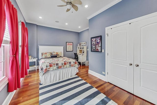 bedroom with baseboards, recessed lighting, wood finished floors, and crown molding