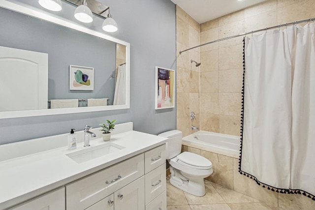 bathroom with tiled shower / bath, vanity, toilet, and tile patterned floors