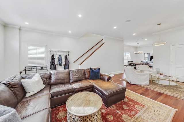 living area with recessed lighting, wood finished floors, and crown molding