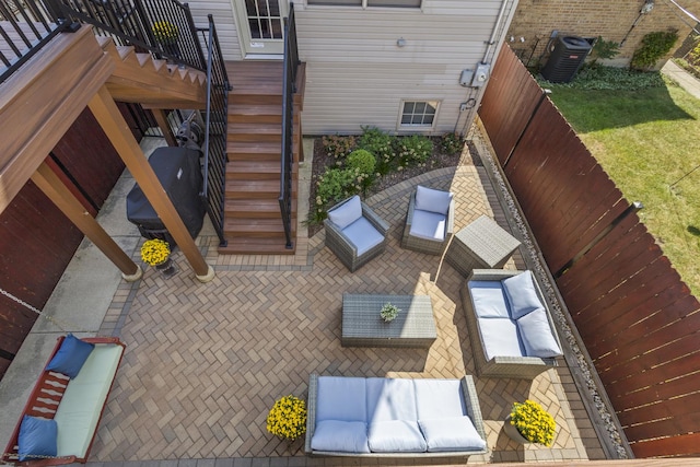 view of patio featuring cooling unit and stairway