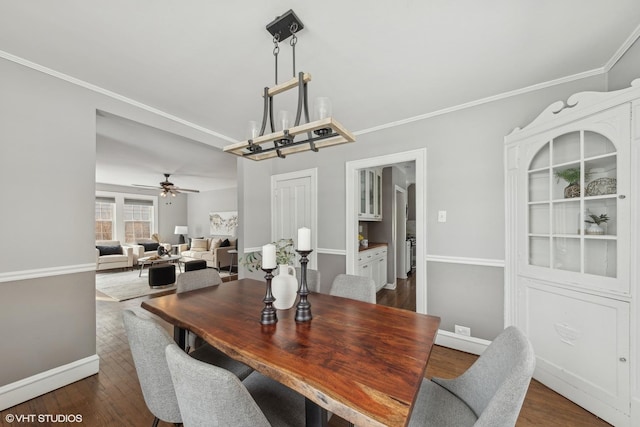 dining room featuring ornamental molding, dark hardwood / wood-style floors, and ceiling fan with notable chandelier