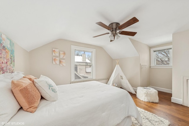 bedroom featuring vaulted ceiling, hardwood / wood-style floors, and ceiling fan