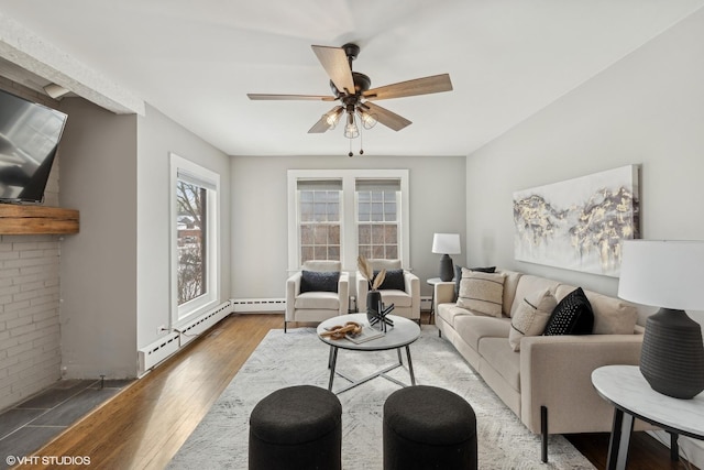 living room with hardwood / wood-style flooring, a baseboard radiator, and ceiling fan