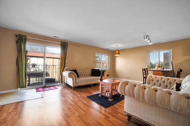 living room with a wealth of natural light and light hardwood / wood-style floors