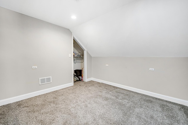 additional living space with baseboards, visible vents, vaulted ceiling, carpet flooring, and recessed lighting