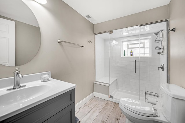 bathroom with visible vents, baseboards, toilet, wood tiled floor, and a shower stall