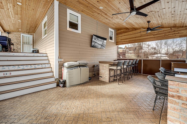 view of patio with outdoor dry bar and ceiling fan