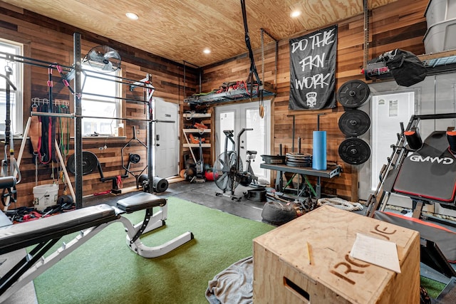 workout room with recessed lighting, wood ceiling, and wooden walls