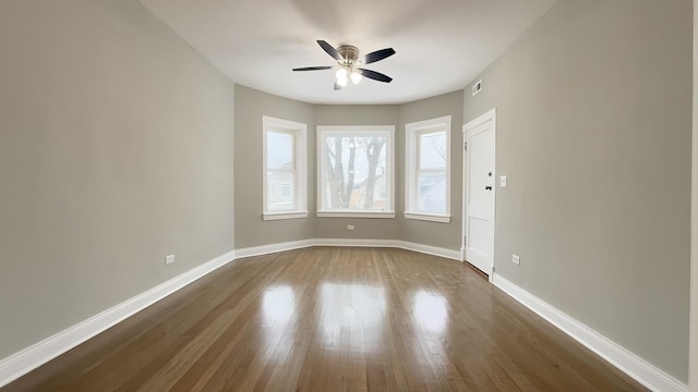 empty room featuring ceiling fan and dark hardwood / wood-style flooring