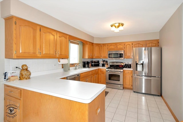 kitchen featuring light tile patterned flooring, sink, tasteful backsplash, kitchen peninsula, and stainless steel appliances