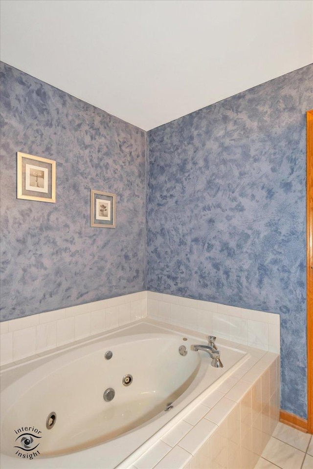 bathroom featuring tile patterned flooring and tiled tub