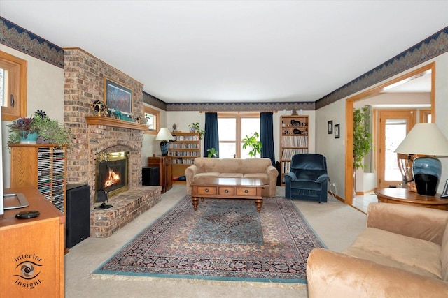 carpeted living room featuring a healthy amount of sunlight and a fireplace