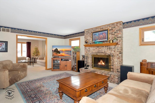 living room featuring light carpet and a brick fireplace