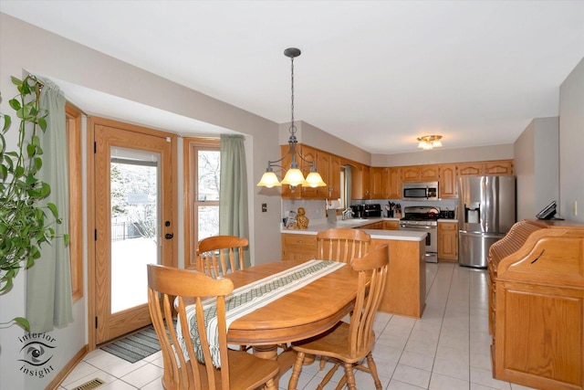 dining space with light tile patterned floors and a chandelier