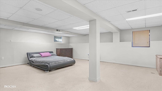 bedroom featuring baseboards, visible vents, and a drop ceiling