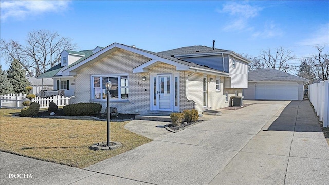 view of front of property featuring central AC unit, fence, an outdoor structure, a front lawn, and brick siding