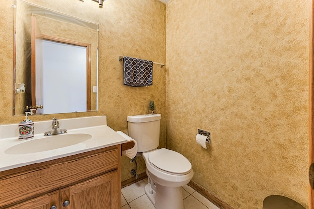 half bath featuring vanity, toilet, and tile patterned floors