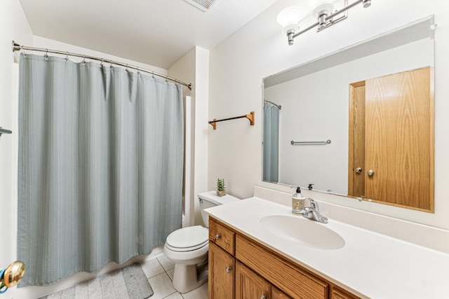 bathroom with toilet, tile patterned flooring, and vanity