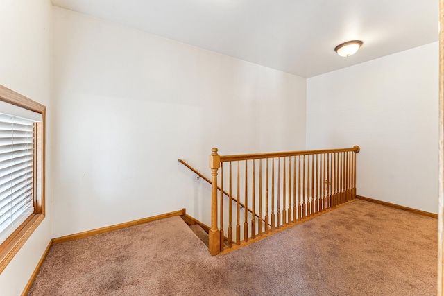 stairway with carpet and baseboards