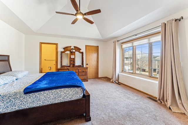 bedroom with baseboards, a ceiling fan, carpet, a tray ceiling, and vaulted ceiling