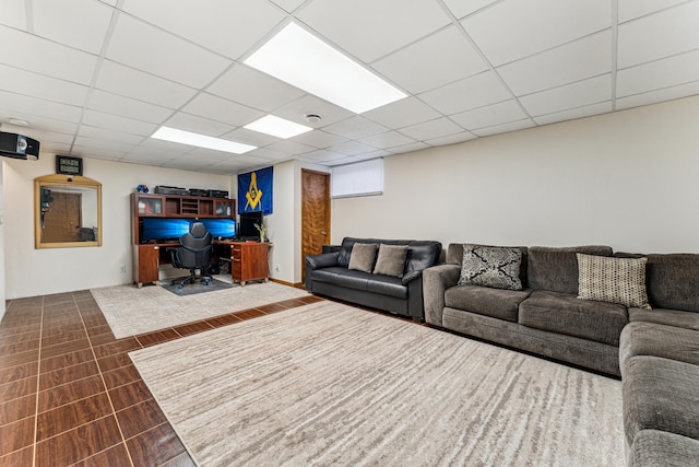 living area with a drop ceiling