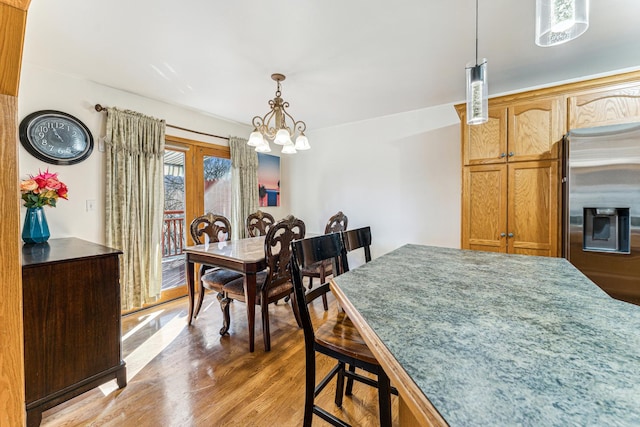 dining area featuring a chandelier and wood finished floors