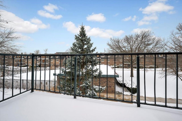 view of snow covered back of property