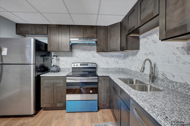 kitchen with dark brown cabinetry, appliances with stainless steel finishes, sink, and light hardwood / wood-style flooring