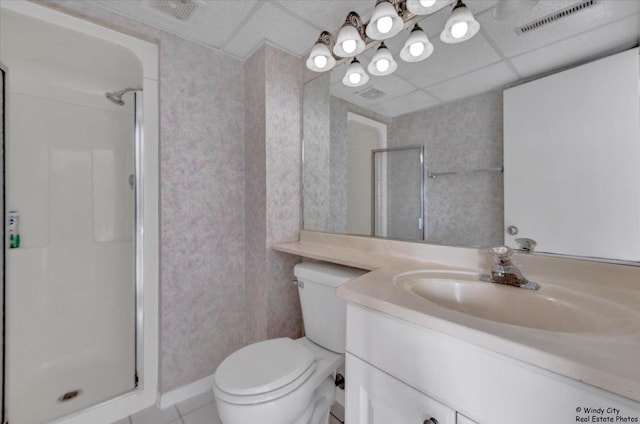 bathroom with tile patterned flooring, an enclosed shower, vanity, a drop ceiling, and toilet