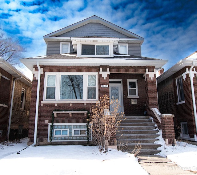 view of front of house featuring brick siding and covered porch