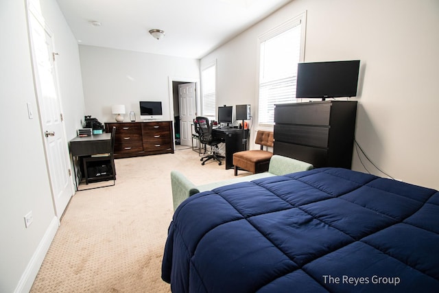 bedroom featuring baseboards and light carpet