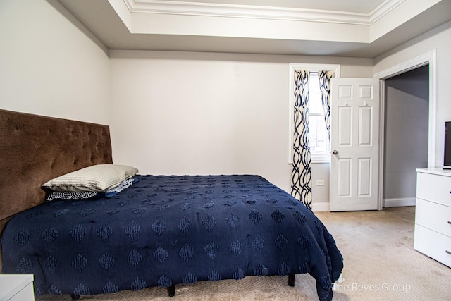 bedroom with a raised ceiling, carpet floors, and ornamental molding