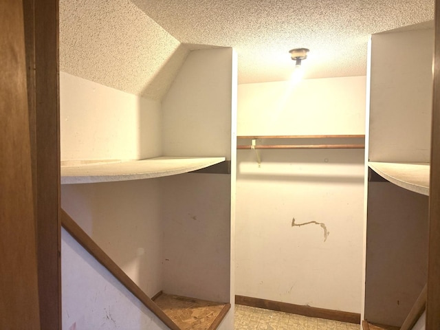 walk in closet with lofted ceiling