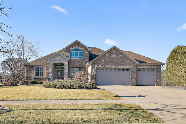 view of front of house featuring brick siding, roof with shingles, concrete driveway, a garage, and a front lawn