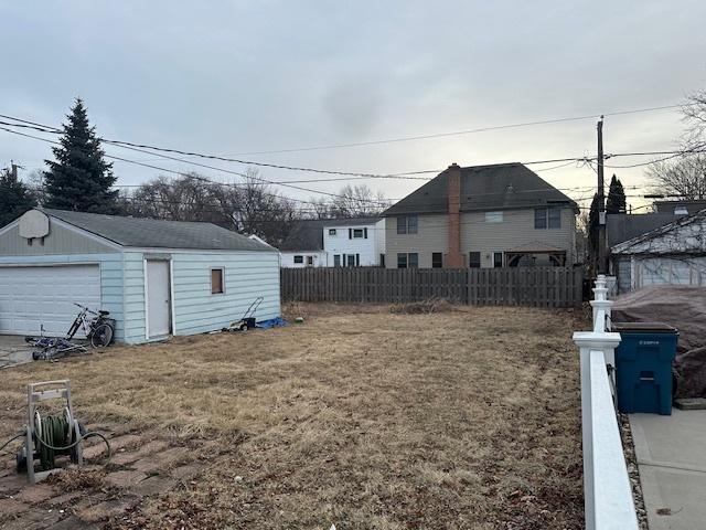 view of yard featuring a garage and an outdoor structure