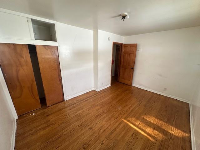 unfurnished bedroom with hardwood / wood-style floors