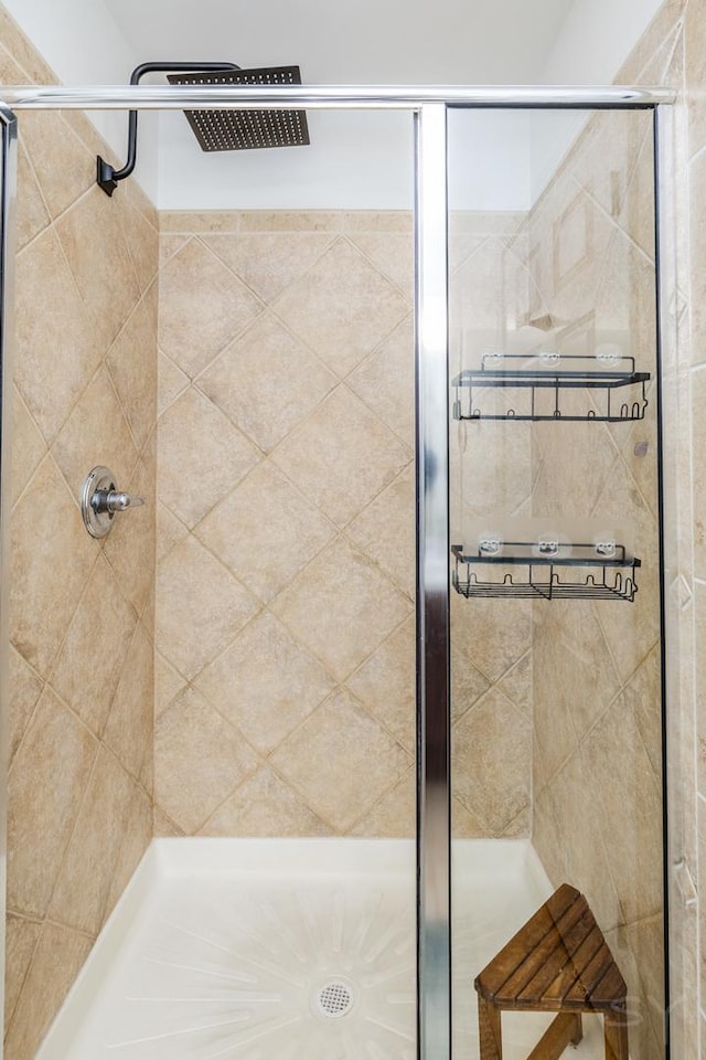 bathroom featuring a shower with door