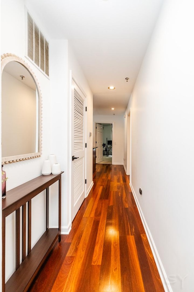 hallway featuring dark hardwood / wood-style flooring