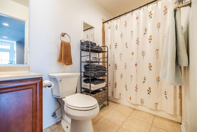 full bathroom with shower / tub combo with curtain, tile patterned flooring, vanity, and toilet