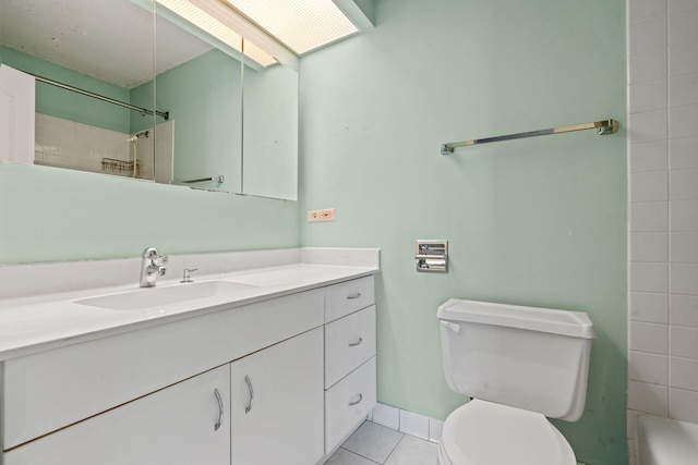 bathroom with toilet, tile patterned flooring, baseboards, and vanity