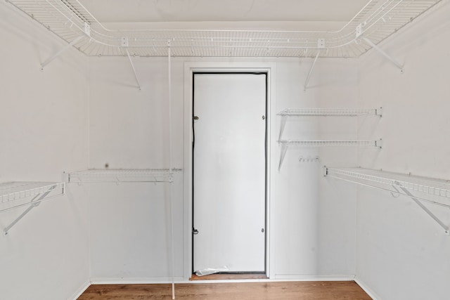 spacious closet with wood finished floors