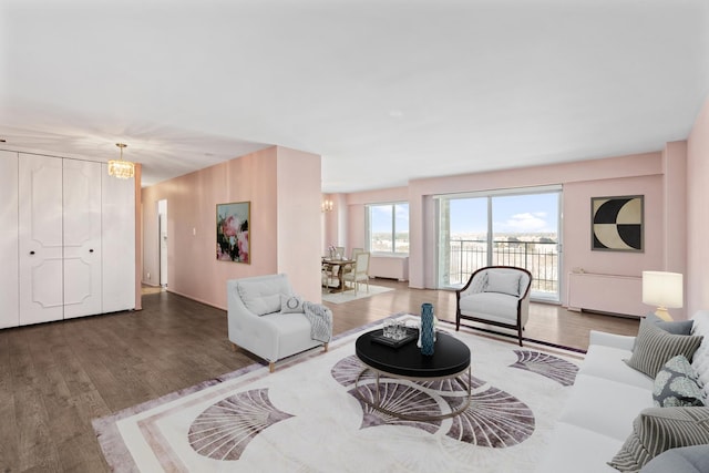 living room featuring wood finished floors and an inviting chandelier