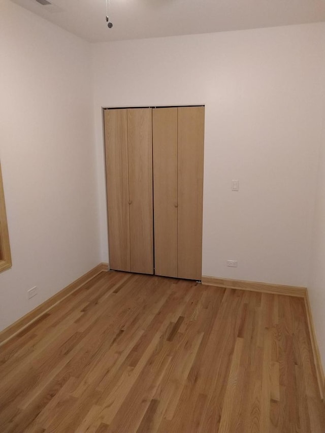 2921 N Kedzie Ave, Chicago, IL 60618 - unfurnished bedroom with light wood-type flooring and baseboards