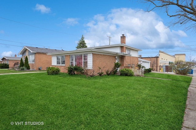 view of front facade with brick siding, a front yard, and a chimney
