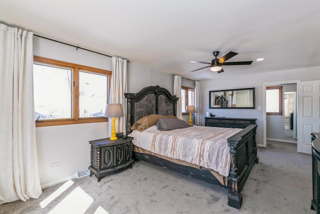 bedroom featuring light carpet, a ceiling fan, visible vents, and baseboards