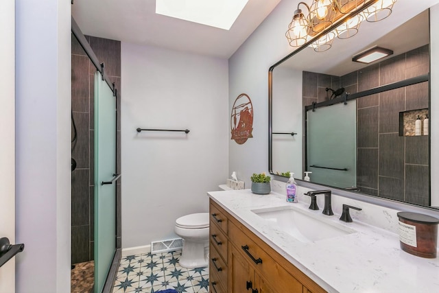 bathroom with a skylight, visible vents, toilet, a tile shower, and vanity