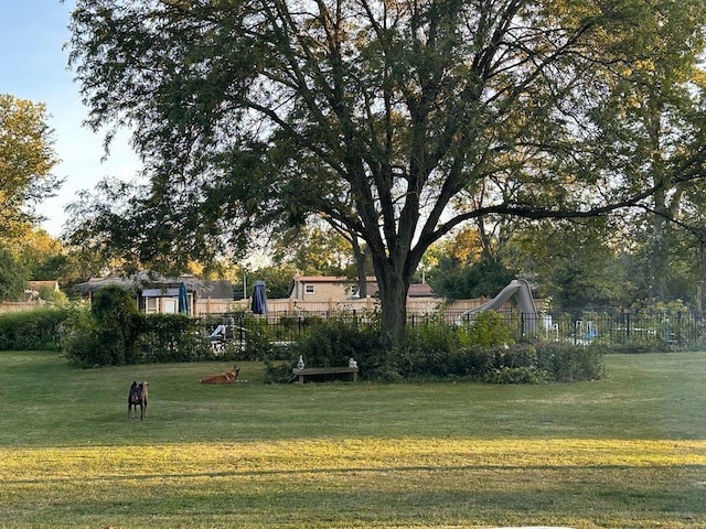 surrounding community featuring fence and a lawn