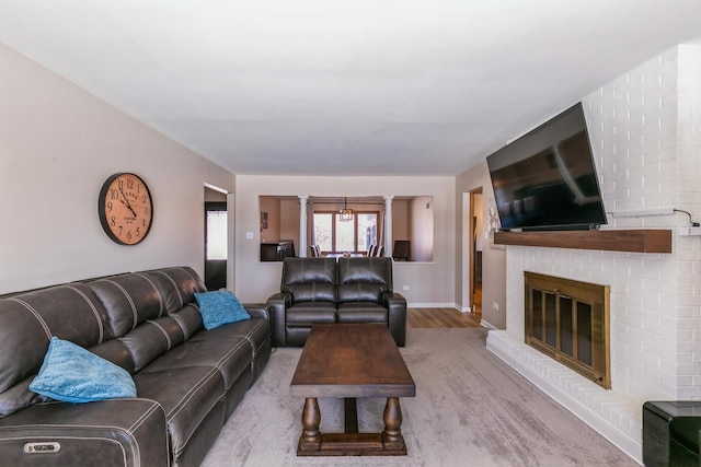 living room featuring a fireplace and baseboards